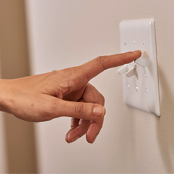 person switching off lights to save energy